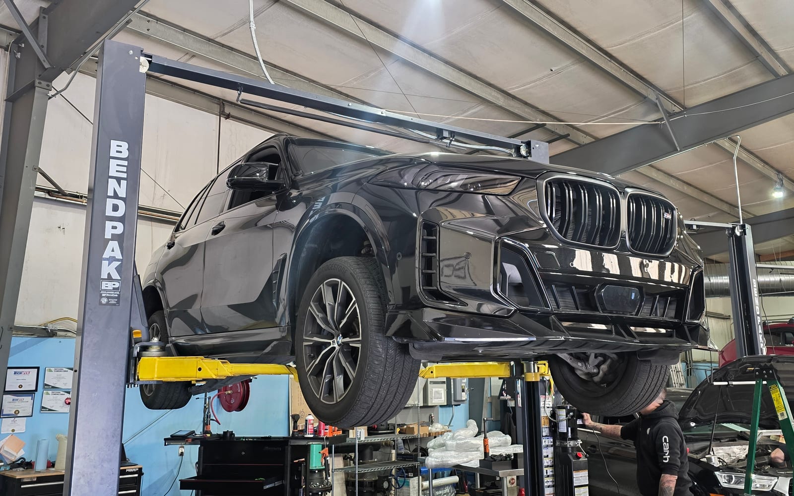 BMW X5 raised on the shop lift