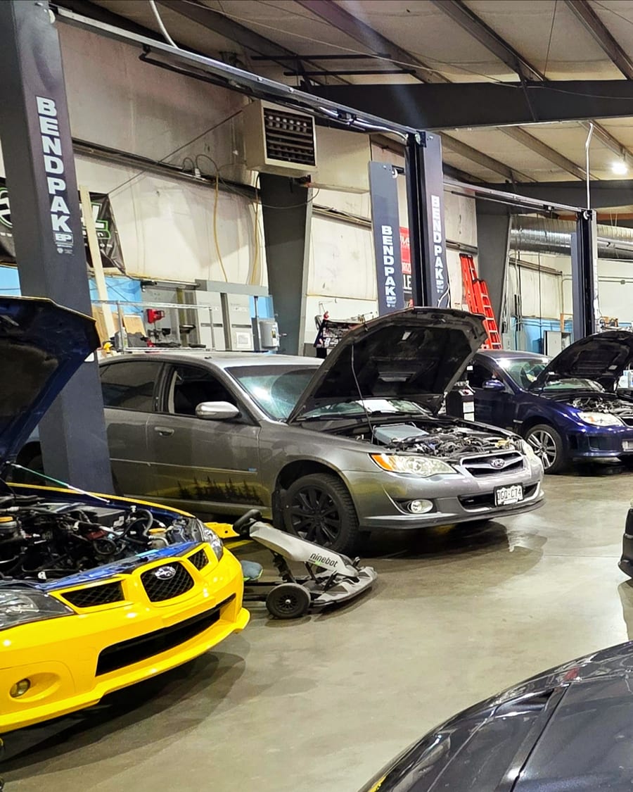 Cars on the lifts in the Cryotune shop bays