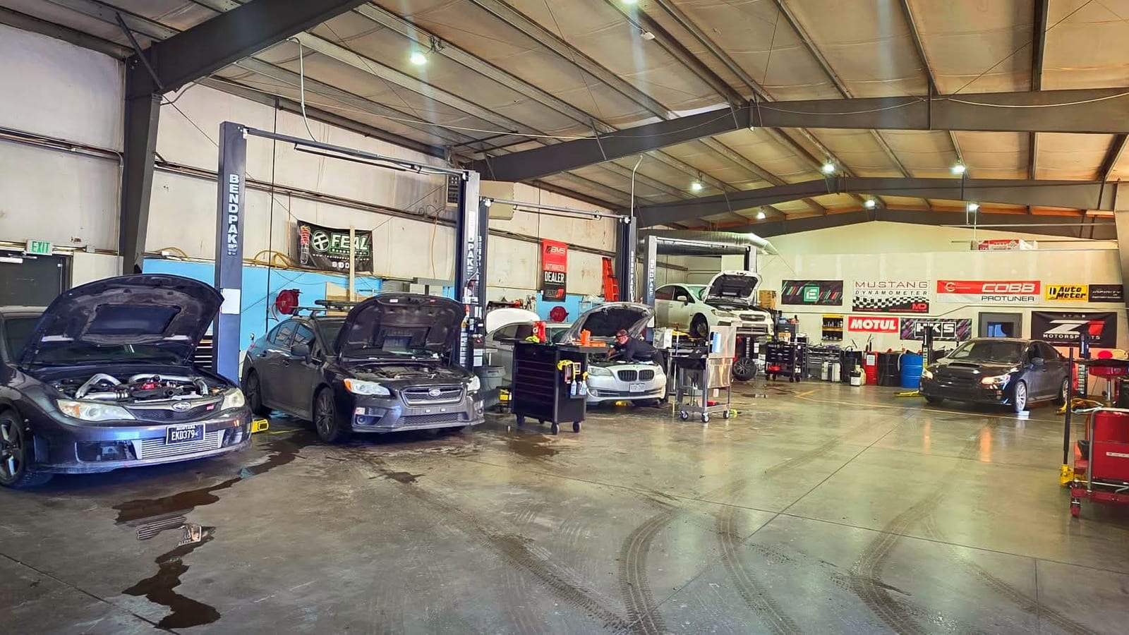Technicians working on cars in the Cryotune service bays